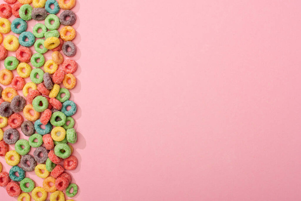 top view of bright colorful breakfast cereal on pink background - Fotó, kép