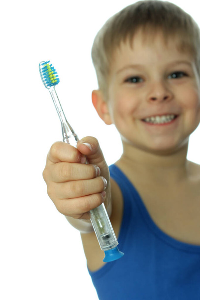 young boy brushing teeth with toothbrush - Fotó, kép