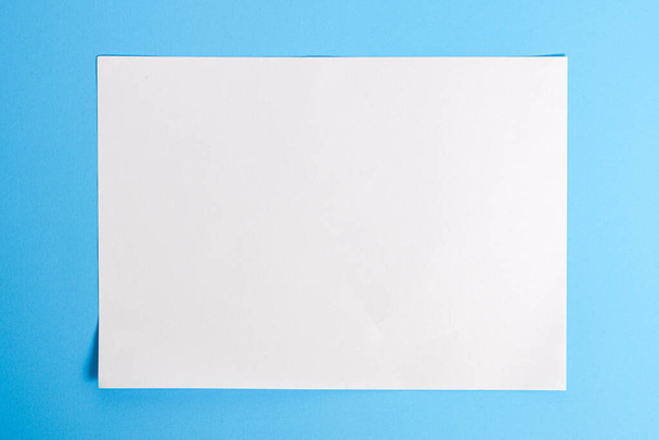 white torn paper with blue background, ready for design - Foto, afbeelding