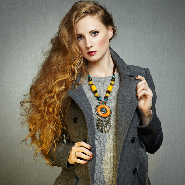 Portrait of young woman in autumn coat - Фото, изображение