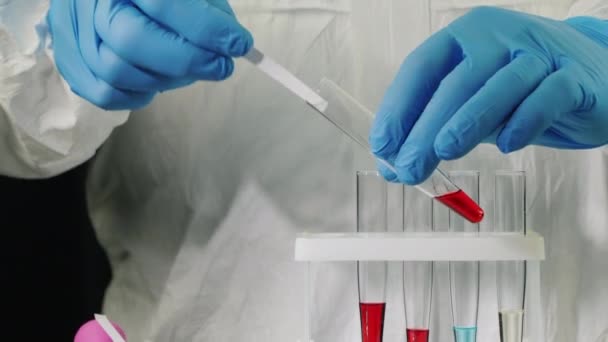 Lab technician in gloves does blood tests - Felvétel, videó