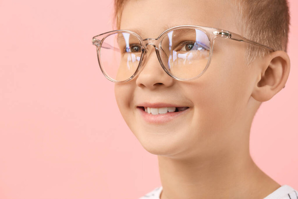 Cute little boy with eyeglasses on color background, closeup - Photo, Image
