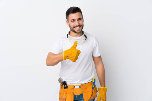Craftsmen or electrician man over isolated white background giving a thumbs up gesture - Photo, Image