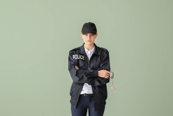 Female police officer on color background - Φωτογραφία, εικόνα