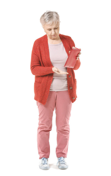 Senior woman with empty wallet on white background - Фото, зображення