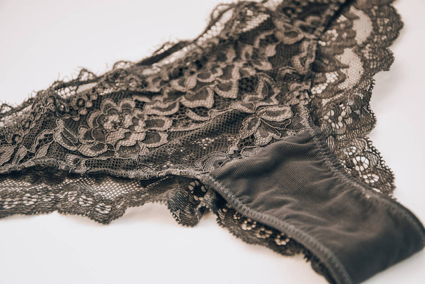 Beautiful female lacy black panties isolated on white background. Sexy underwear, - Photo, Image