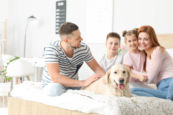 Happy family with dog in bedroom at home - Foto, imagen