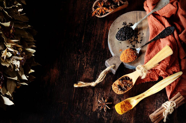 Mix of spices on a dark wooden background. - Photo, Image