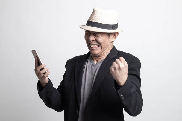 Happy Adult Asian man  with mobile phone on white background - 写真・画像