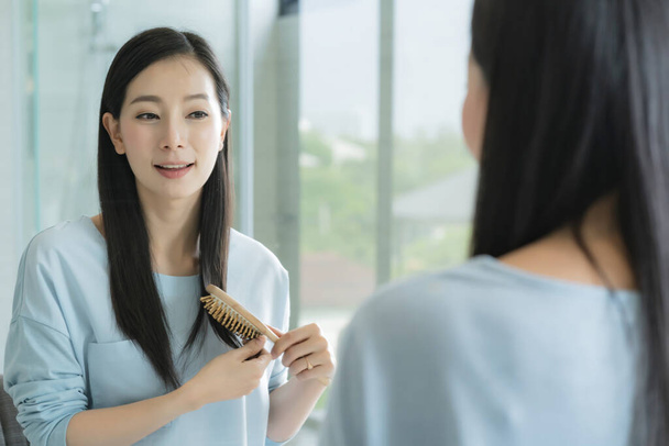beautiful asian woman makeup and hair set wirh mirror in bathroom with morning light - Fotó, kép