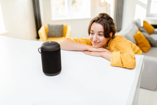 Woman controlling smart home devices with a voice commands - Photo, Image