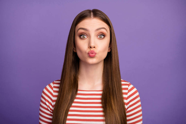 Closeup photo of attractive student lady long hairdo sending air kisses funny facial expression flirty mood wear casual striped shirt isolated pastel purple color background - Foto, Bild