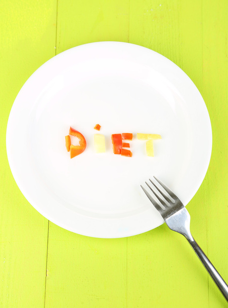 Word diet lined vegetables on plate on wooden table close-up - Foto, Imagem