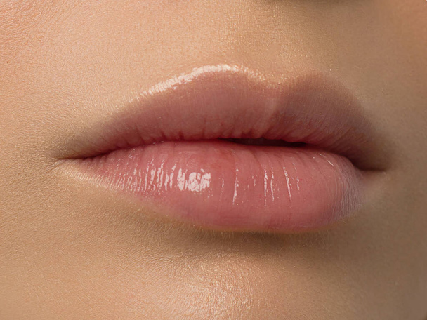Closeup plump Lips. Lip Care, Augmentation, Fillers. Macro photo with Face detail. Natural shape with perfect contour. Close-up perfect natural lip makeup beautiful female mouth. Plump sexy full lips - Фото, изображение