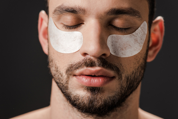 handsome man with eye patches on face isolated on grey - Foto, Imagem