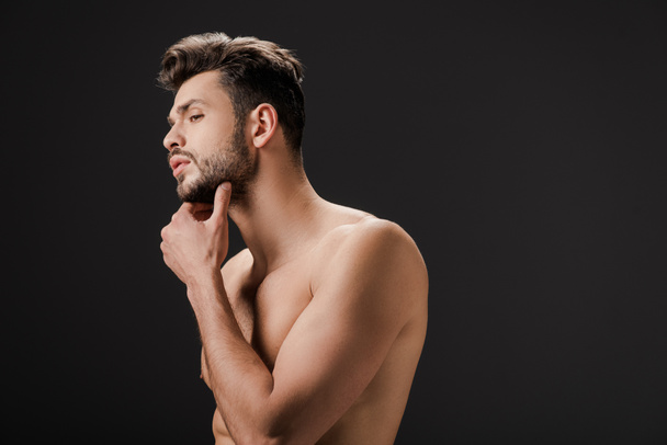 handsome sexy naked man touching beard isolated on black - Foto, Bild