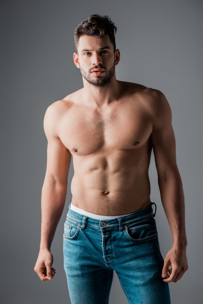handsome sexy muscular man in jeans isolated on grey - Φωτογραφία, εικόνα
