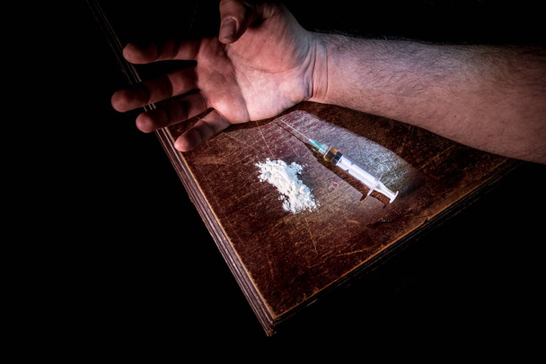 Έννοια περί προβλήματος ναρκωτικών. Σύριγγα ναρκωτικών και ναρκωτικές ιδιότητες σε ξύλινο τραπέζι. Η αγορά, κατοχή και πώληση ναρκωτικών τιμωρείται από το νόμο. Δημιουργική διακόσμηση - Φωτογραφία, εικόνα