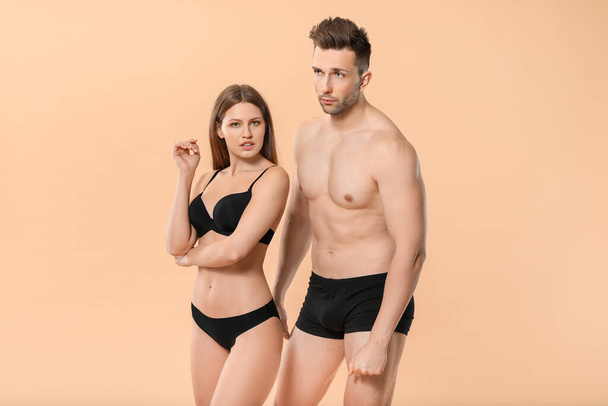 Young couple in underwear on color background - Zdjęcie, obraz