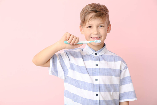 Cute little boy with toothbrush on color background - Photo, image