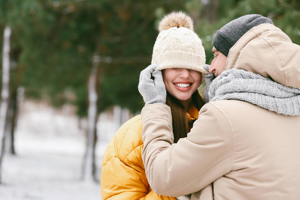 Happy young couple in park on winter day - Фото, зображення