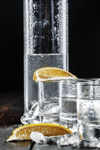 Vodka in shot glasses on rustic wood background - Photo, Image