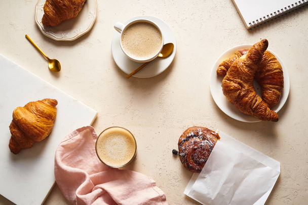 coffee and croissants on table. Breakfast in bakery concept - Foto, imagen