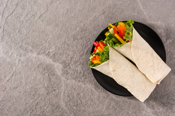 Vegetable tortilla wraps on gray stone background top view copy space - Photo, Image