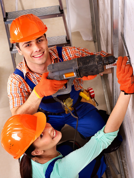 Family in builder uniform indoor. - Photo, Image
