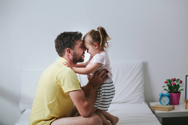 Father and daughter playing on bed - Foto, Imagem