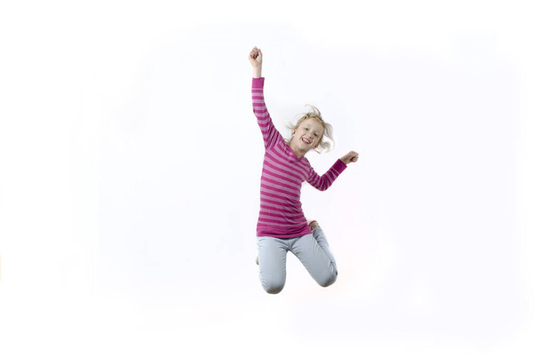 girl in a pink shirt jumping - Φωτογραφία, εικόνα