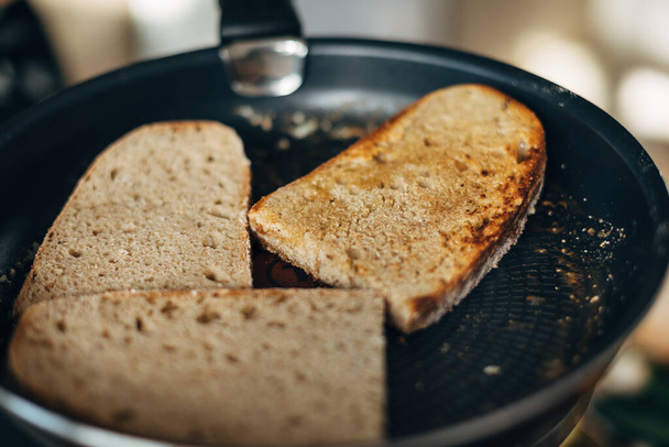 Chef toasting whole wheat bread in a pan with butter - Photo, image