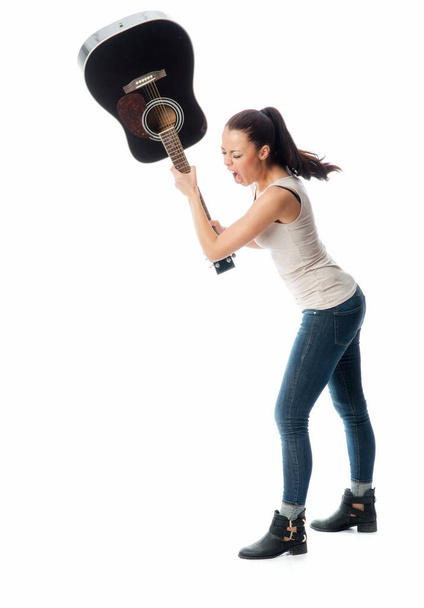 Young woman smashes a guitar - Photo, Image