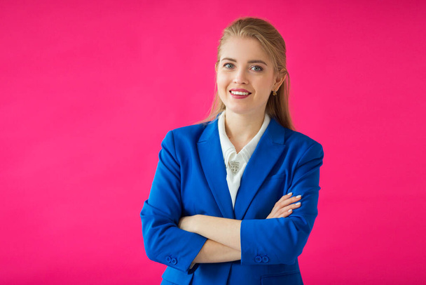 beautiful young woman in a blue jacket on a pink background - Fotografie, Obrázek