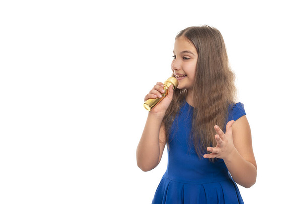Attractive young girl brunette wearing blue dress  sings song while holding microphones in their hands against white background - Photo, Image