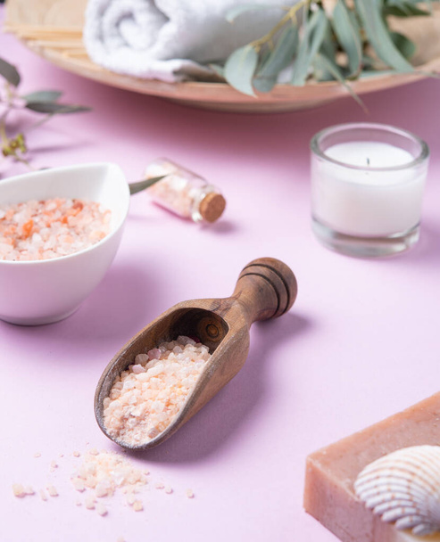 natural organic cosmetics with pink Himalayan salt, soap and eucalyptus branch on a pink background. Aromatherapy and Spa treatments - Φωτογραφία, εικόνα