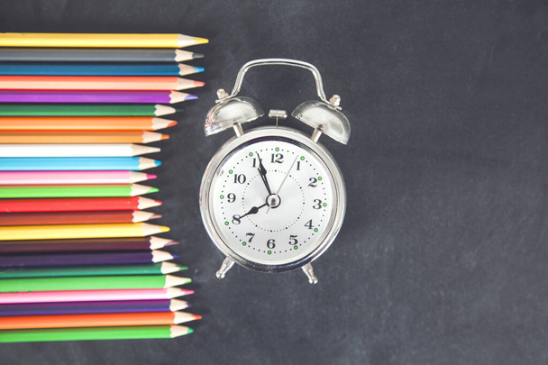 colorful pencils with clock on the chalkboard - Zdjęcie, obraz