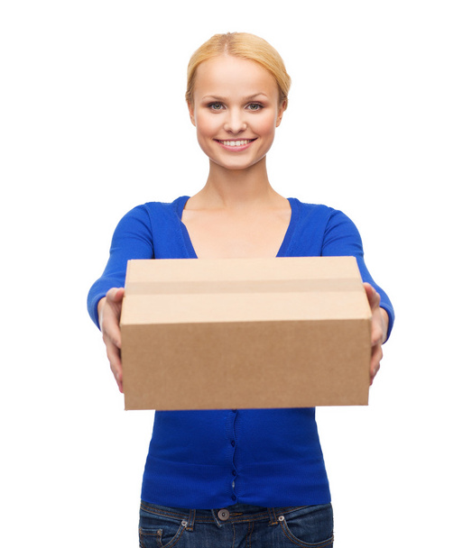 Smiling woman in casual clothes with parcel box - Fotó, kép