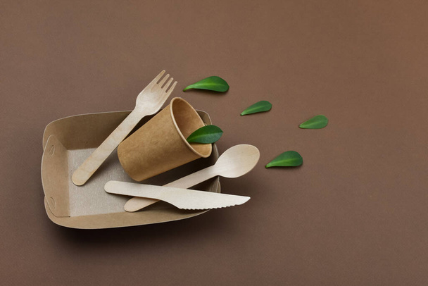 Zero waste, environmentally friendly, disposable, cardboard, paper tableware. Green leaflets. - Photo, Image