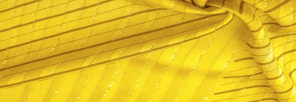 Textura de fondo de diseño, tejido ámbar amarillo con rayas lurex, perfecto para un estilo fresco y cómodo. - Foto, imagen