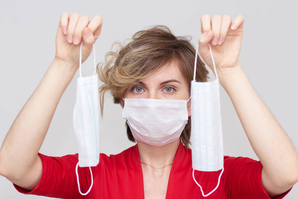 Cute girl wearing a health mask, looking straight, isolated on a white background, flu Epidemic, dust Allergy, virus protection. Concept of air pollution in the city, close-up - Photo, image