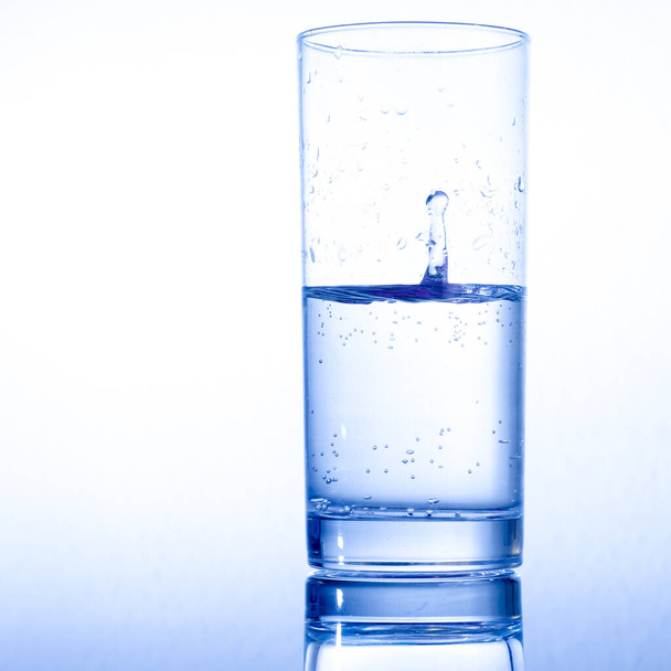 glass of water with ice cubes on white background - Photo, Image