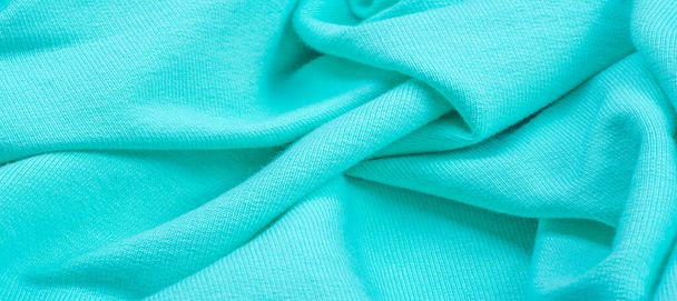 Texture, sfondo, pattern. Il tessuto è lavorato a maglia blu, turchese, blu. Aggiungerò un approccio creativo al tuo prossimo progetto. Con questo tessuto, sarai il primo colore delicato di cui hai bisogno. - Foto, immagini
