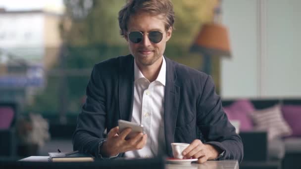Young Businessman Sitting At The Cafe And Speaking On The Phone. - Materiał filmowy, wideo