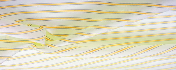relief drawing, composite textiles, dense silk fabric of white color, yellow, amber, golden and gray lines, a stroke on the fabric, a narrow strip. feature, line, stroke, dash, trace, - Photo, Image