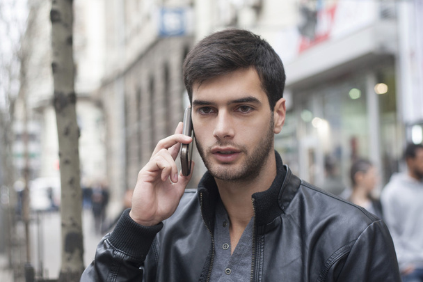 Young Man talking with cell phone - Φωτογραφία, εικόνα
