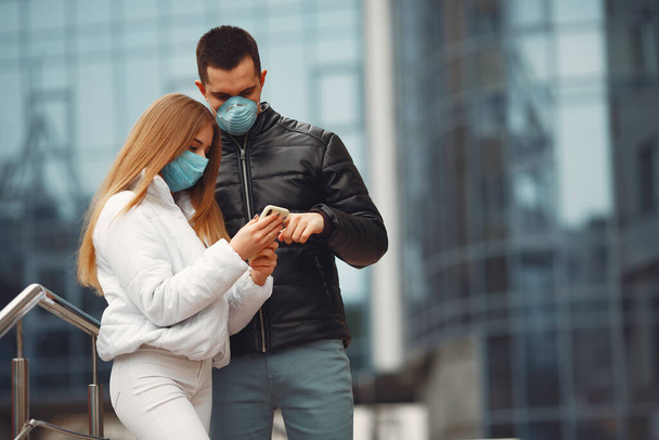 Boyfriend and girlfriend are making selfie and wearing disposable masks - Fotoğraf, Görsel