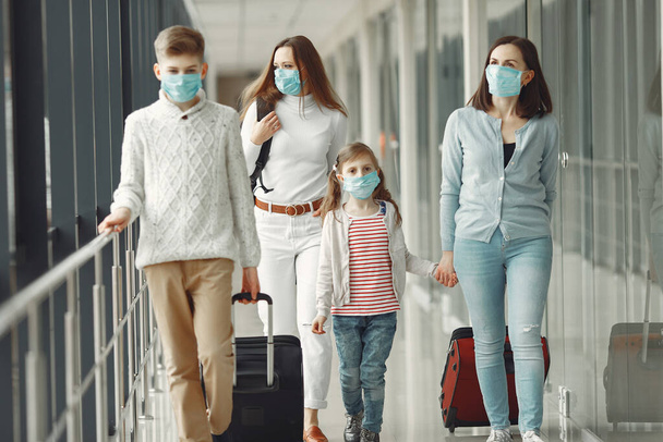 People in airport are wearing masks to protect themselves from virus - Foto, imagen