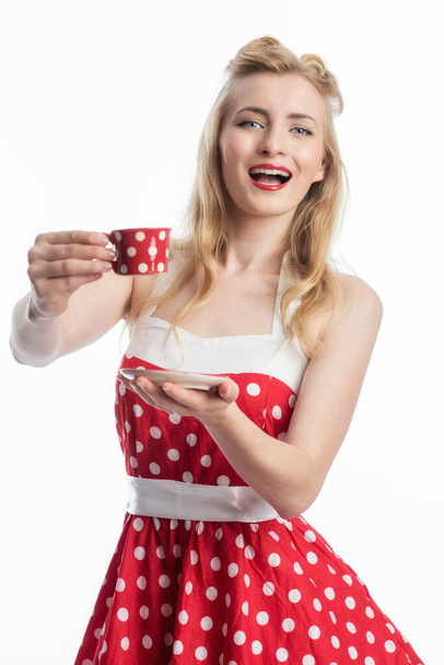a woman in a summer dress holds a coffee cup - Фото, изображение