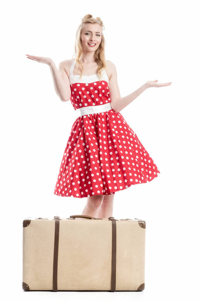 a pin up girl with suitcase gesticulated with her hands - Foto, Bild